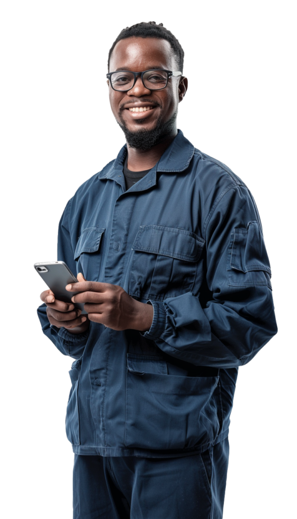 A man wearing glasses, smiling, in work clothes, holding a phone.